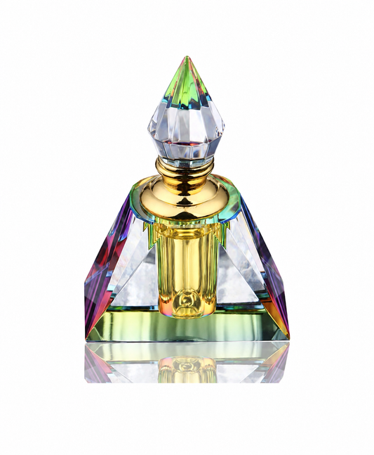 Blue Lotus Oil in a faceted crystal bottle with translucent golden oil on a white background
