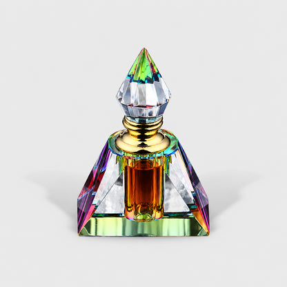 Wild Aged Oud Oil in the pyramid-shaped crystal bottle with amber-brown liquid.