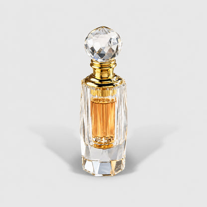Rose Oil in the cylindrical faceted crystal bottle with a spherical stopper and amber liquid.